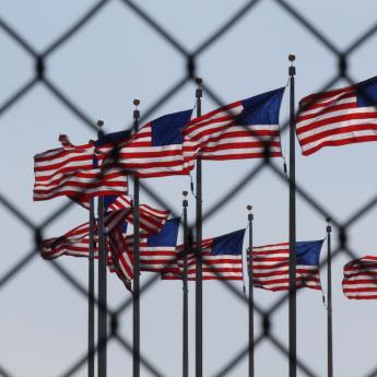 U.S. flags behind wire fence