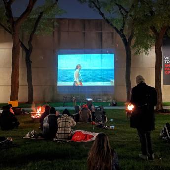 Visitors watch a film outdoors at UChicago's Smart Museum