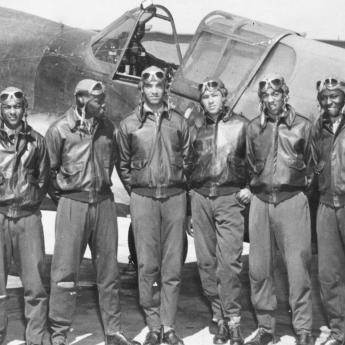 Tuskegee Airmen in front of plane 