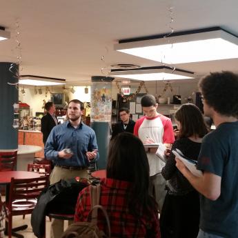 Group of people standing around in a cafe