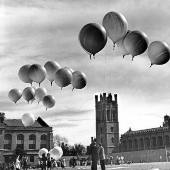 Old photo of people holding balloons