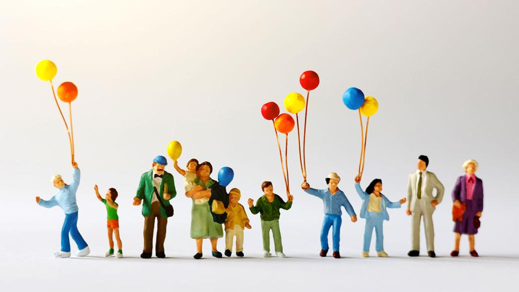 Miniature figures holding balloons