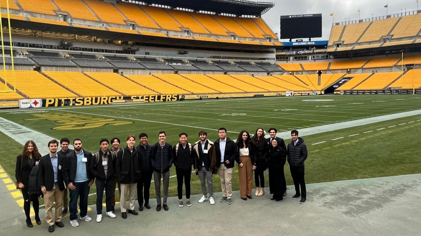 Students stand on the Pittsburgh Stealers field for a group photo.