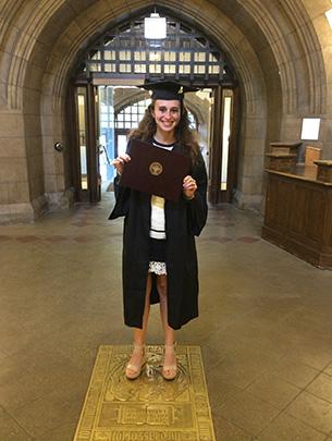 Sarah Langs poses with her diploma on campus at the University of Chicago