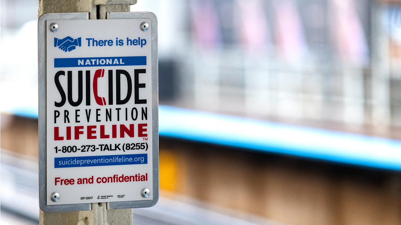 Sign reading "There is help. National suicide prevention lifeline: 1-800-273-TALK (8255). Free and confidential."