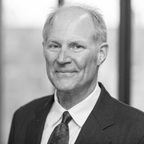 Prof. John Mark Hansen, a man in a suit with short hair