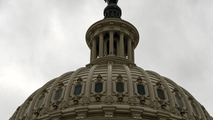 The U.S. Capitol Building backgrounded by stormy skies