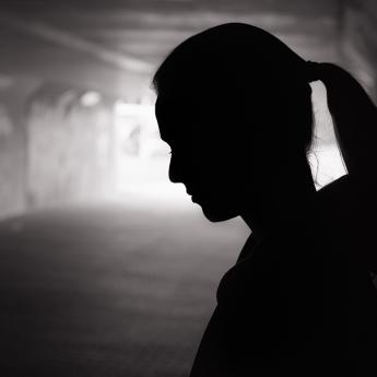 Woman standing dark tunnel