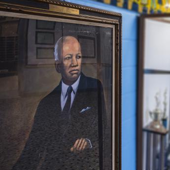 A portrait of Carter G. Woodson hangs in the hallway at Carter G. Woodson South Elementary School in Chicago. 