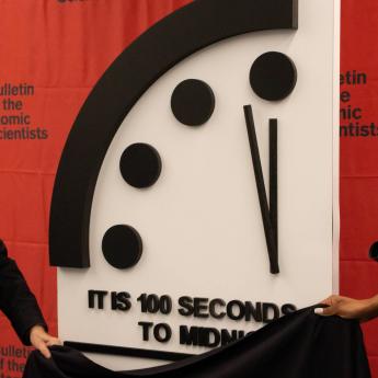 Bulletin of Atomic Scientists board members Robert Rosner and Suzet McKinney pull cloth away to reveal 2021 Doomsday Clock