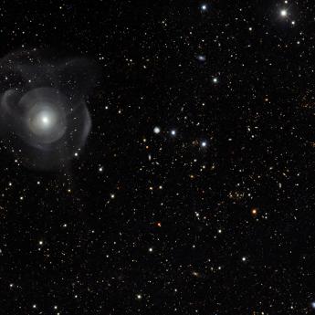 Image of the night sky taken by the Dark Energy Survey, featuring several spiral galaxies and many stars