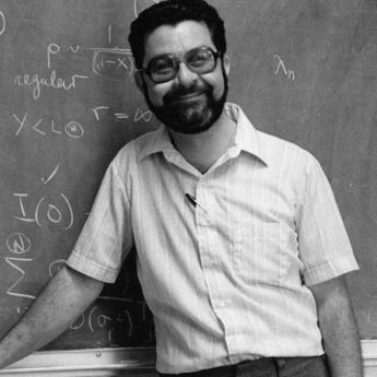 Victor Barcilon standing in front of a blackboard in 1980