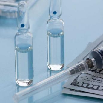 Vaccine vials on top bills
