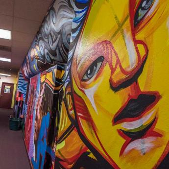 A mural-covered hallway at an IDJJ youth center in East Garfield Park, Chicago.