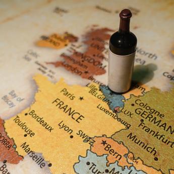 Wine bottle sitting on a map of Europe