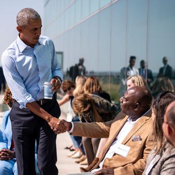 President Barack Obama shakes hands as he walks through a crowd