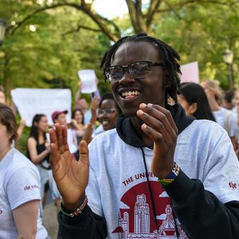 Student claps as the marches through the UChicago campus