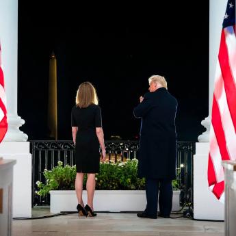 Former President Donald Trump stands next to Supreme Court Justice Amy Coney Barrett