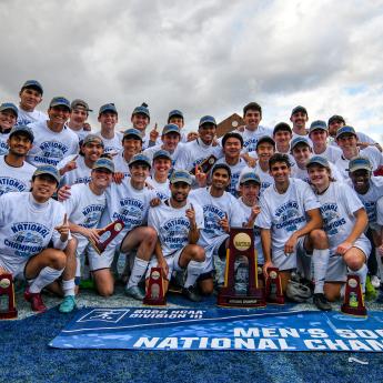 Members of the UChicago men's soccer team pose with the NCAA Division III trophy