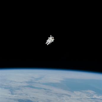 An astronaut floats above the earth