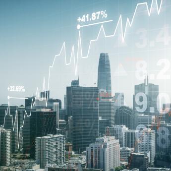 Photo illustration showing cityscape with stock market charts