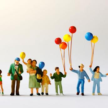 Miniature figures holding balloons