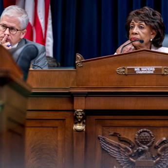 Representatives Patrick McHenry and Maxine Waters sit at microphones