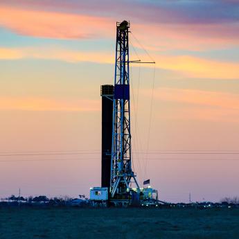 A drilling rig at sunset