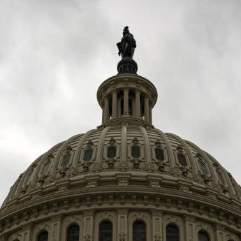 The U.S. Capitol Building backgrounded by stormy skies