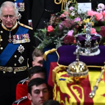 King Charles III walks beside the coffin of Queen Elizabeth II at Westminster Abbey in London 