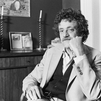 Kurt Vonnegut reclines with one hand supporting his chin