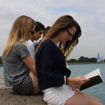 Undergraduates read books on a summer day on Lake Michigan