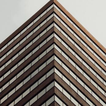 The corner of an office building seen from below