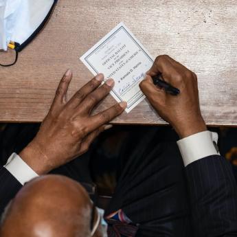 NYTimes photo of elector signing his ballot