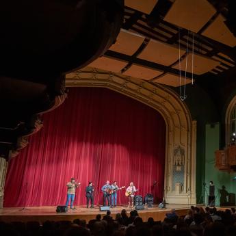 Musicians perform on stage at the 2024 Folk Festival