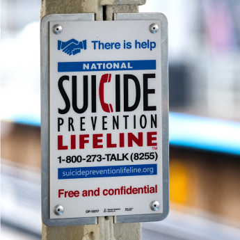 Sign reading "There is help. National suicide prevention lifeline: 1-800-273-TALK (8255). Free and confidential."