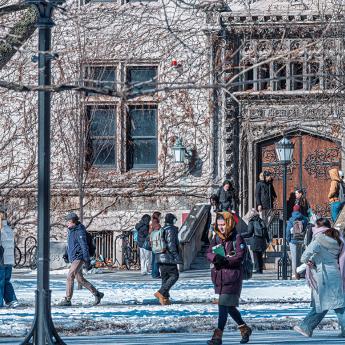 Students walk through snow on campus