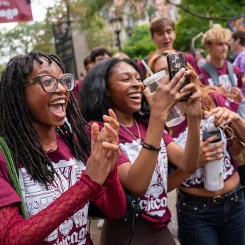 Students cheer and celebrate as they pass through Cobb Gate