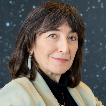 Photo of Prof Wendy Freedman in white jacket with backdrop of stars