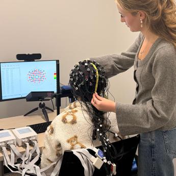 Fourth-year Bella Summe collects neural data using fNIRS