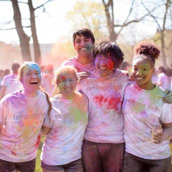 Students covered in colored powder for Holi