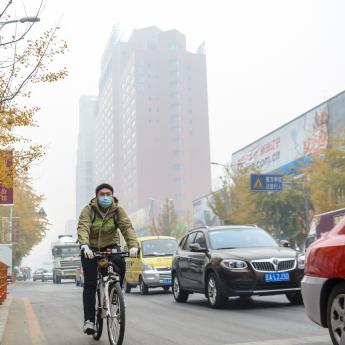 Man biking on a street in China