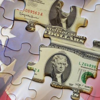 US money and flag as puzzle pieces