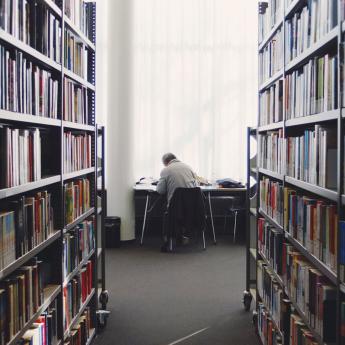 Person sitting at desk in library