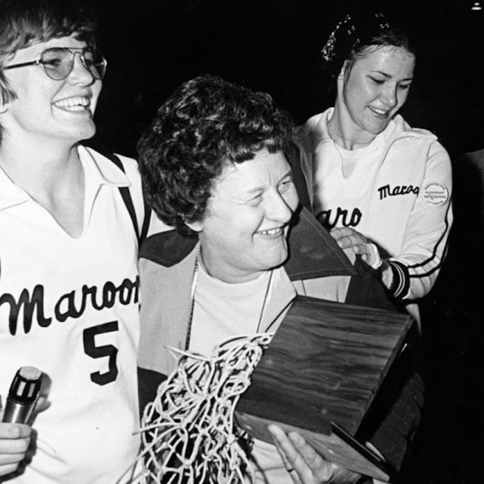 Patricia Kirby (center), head basketball coach at the University of Chicago, celebrates the team's win at the 1976 Brown University Invitational. Kirby is pictured with team captains Laura Silvieus (left) and Vadis Cothran (right).