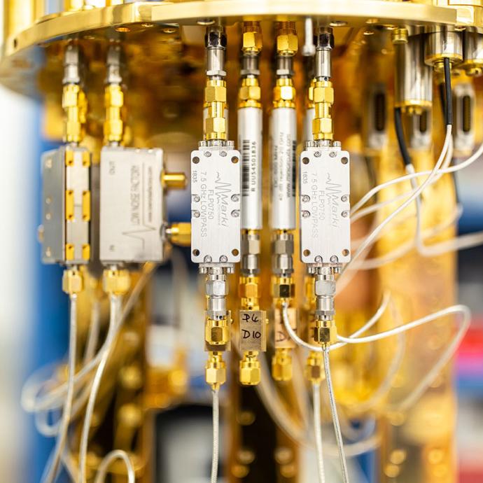 Closeup of a circular upright instrument with brass features used for superconducting quantum technology research
