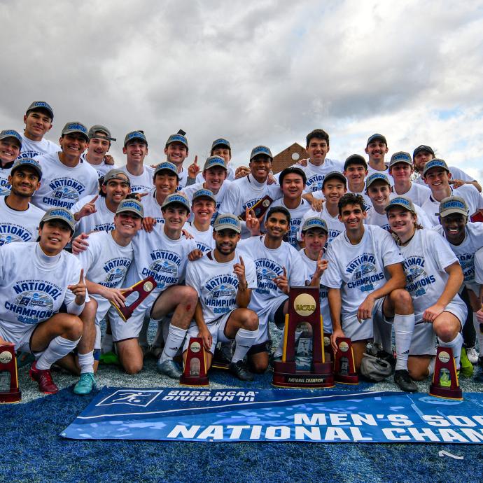 Members of the UChicago men's soccer team pose with the NCAA Division III trophy