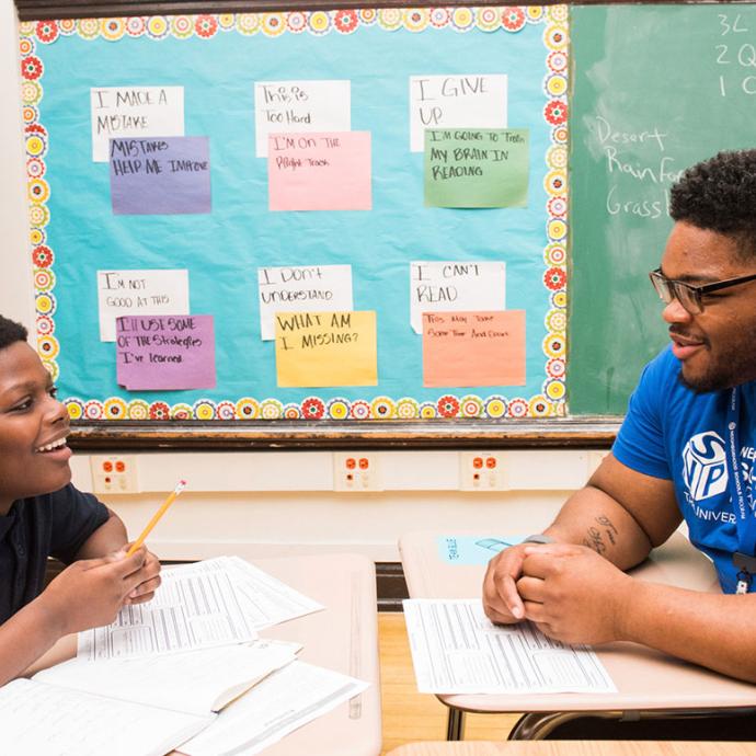 Anthony Halmon talking with a CPS student in the classroom,
