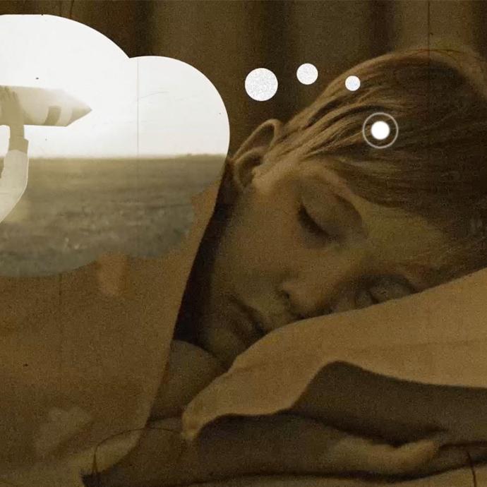 A child sleeping with a dream bubble graphic floating out of their head