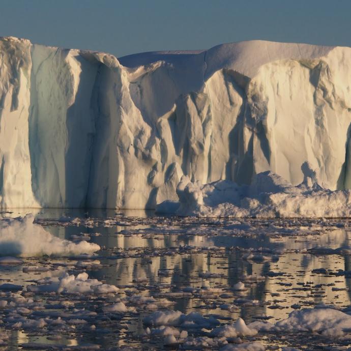 Icebergs fall off a glacier in Greenland